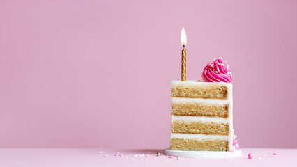 Slice of birthday cake with gold birthday cake candle and pink frosting