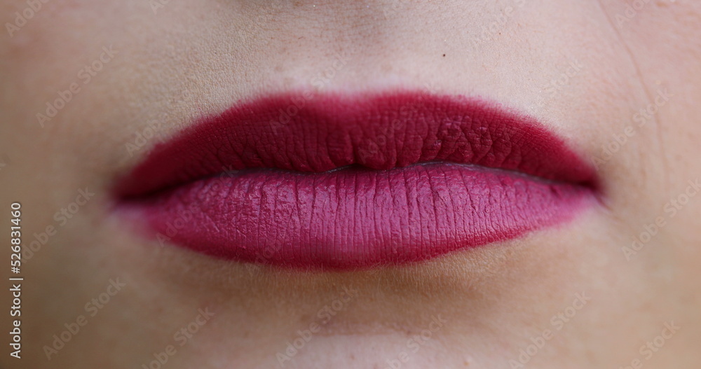 Fototapeta premium Lips macro closeup detail. Woman wearing red lipstick close-up face