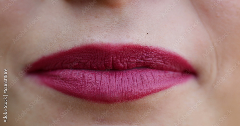 Lips macro closeup detail. Woman wearing red lipstick close-up face Lips macro closeup detail. Woman wearing red lipstick close-up face