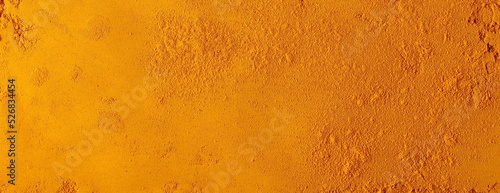 Turmeric (Curcuma) powder pile background and texture, top view photo