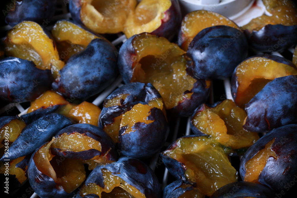 Fototapeta premium halves of plums are laid out on a tray for drying