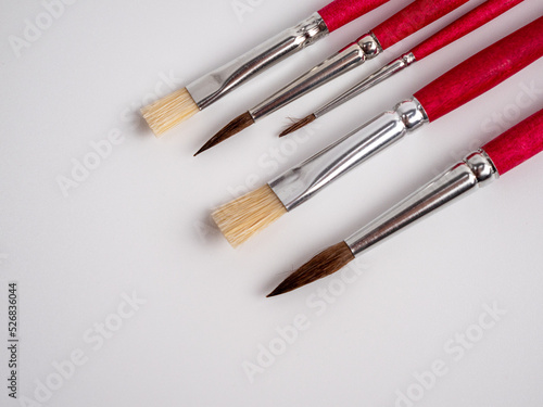 Various artist's brushes on a white background.