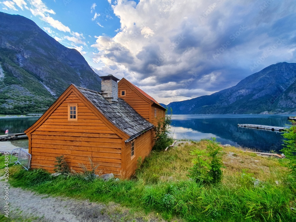 wooden house against the backdrop of mountains and fjord - Eidfjord wooden house against the backdrop of mountains and fjord - Eidfjord
