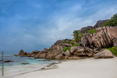 Beautiful nature of the sea tropical landscape. Exotic tropical nature of the Seychelles, a white beach surrounded by palm trees and granite rocks.