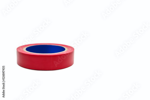 Skein of red electrical tape on a white background. Tool for insulating wiring in electrical systems. Reel of electrical tape for electrical work during construction. Free space for text