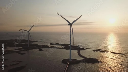 Landscape of coast with wind generator in Woljeong-ri, Jeju, Korea. Jeju Island is famous for beautiful nature and natural World heritage sites. (aerial photography) photo