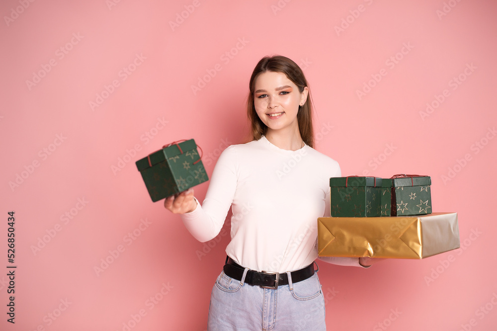 Cute girl holding gift boxes and laughing Cute girl holding gift boxes and laughing