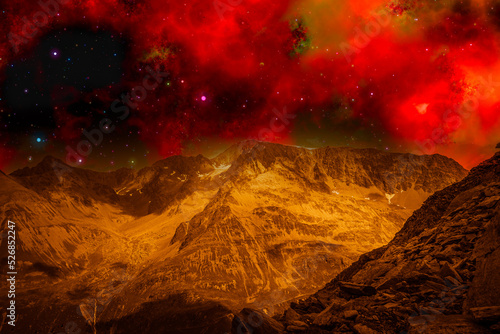 Photo montage that recreates a mountainous landscape on an alien planet. Fantasy image of mountains from another planet under a red space sky with stars and nebulas