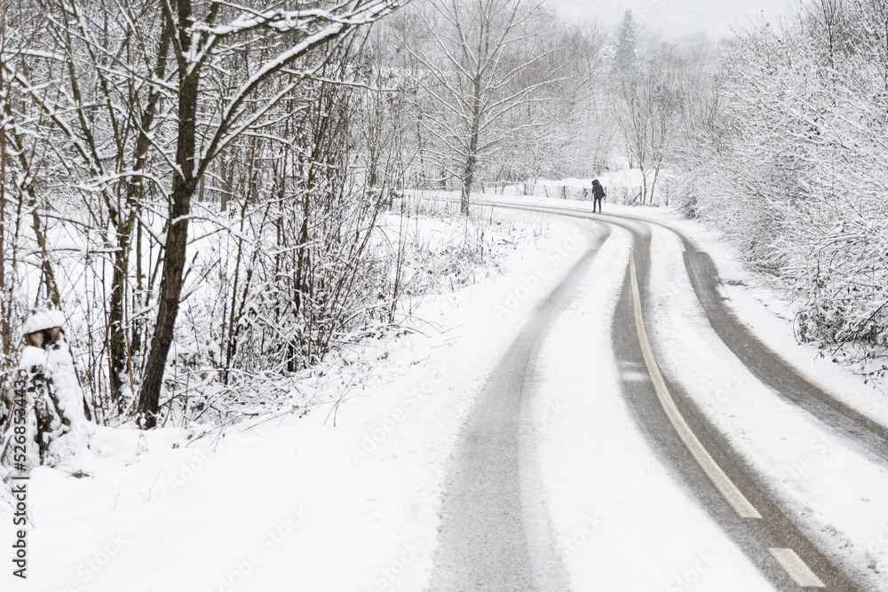 A woman on a snow-covered road A woman on a snow-covered road
