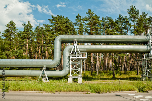 pipeline, in the photo the pipeline against the background of the blue sky and forest