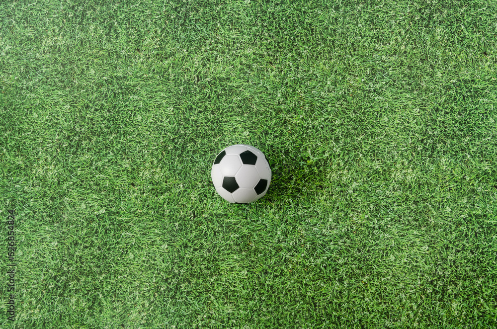 A football ball on green grass. Creative concept for Qatar FIFA World Cup 2022 advertisement of banner. Design for soccer matches tv commercial A football ball on green grass. Creative concept for Qatar FIFA World Cup 2022 advertisement of banner. Design for soccer matches tv commercial