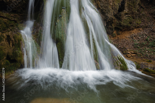 Beautiful waterfall splashing over mossy rocks