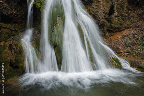 Beautiful waterfall splashing over mossy rocks