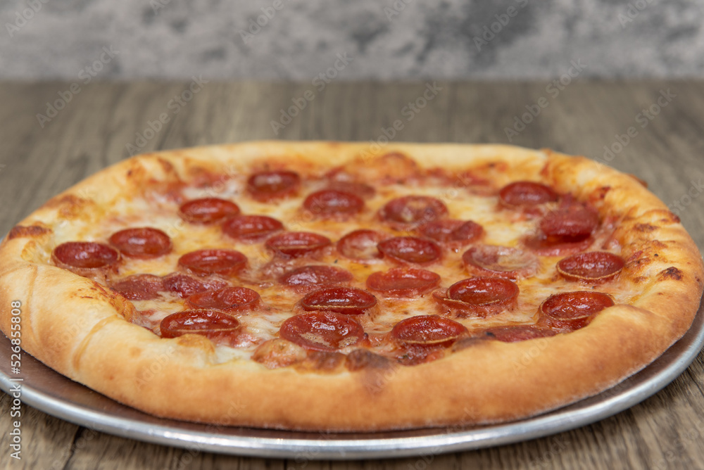 Hot from the oven is a crispy crust Italian baked pepperoni pizza that is ready to eat