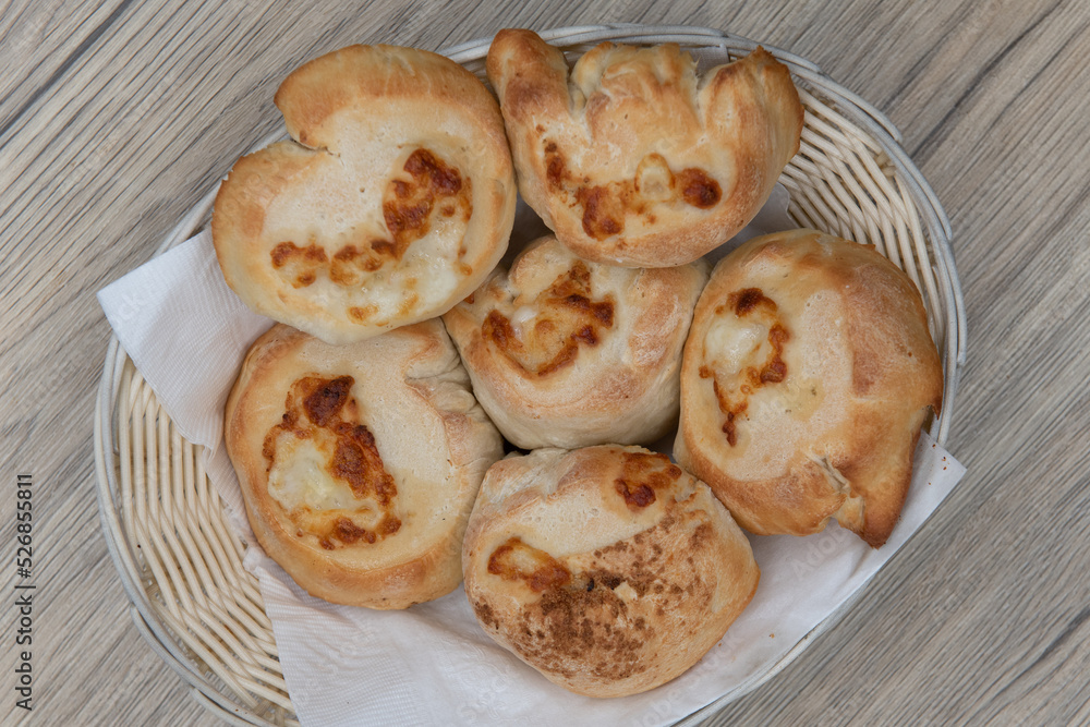 Overhead view of full basket of garlic and cheese rolls makes the perfect appetizer before an Italian food meal Overhead view of full basket of garlic and cheese rolls makes the perfect appetizer before an Italian food meal