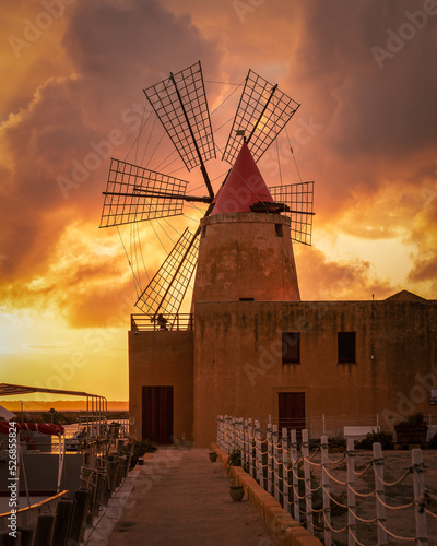 Vertical shot of Saline of Trapani and Pacheco, Italy, during a beautiful orange sunset photo