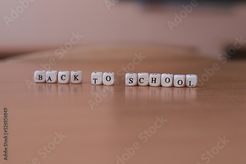 the inscription of the letters back to school on the school desk in the classroom. Minimalism. copy space