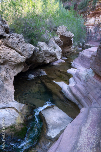 river flowing through the red stone canyon in Fuentes de Ayodar, Spain. photo