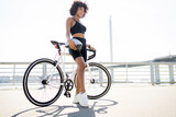Young woman uses bicycle eco transport in the city, fitness cardio workout