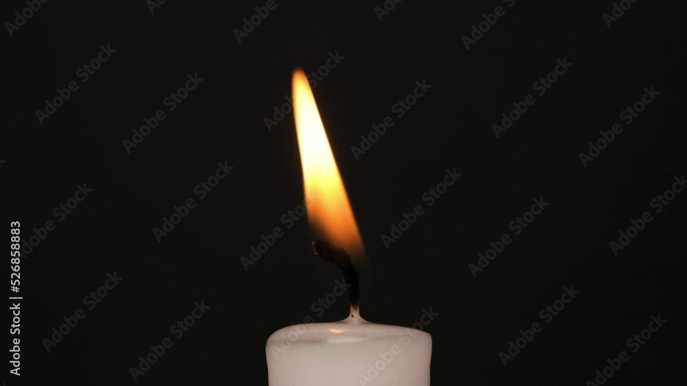 White single Candle flickering in the dark. Side view. White candle burning on the dark background. Slow motion full HD video White single Candle flickering in the dark. Side view. White candle burning on the dark background. Slow motion full HD video
