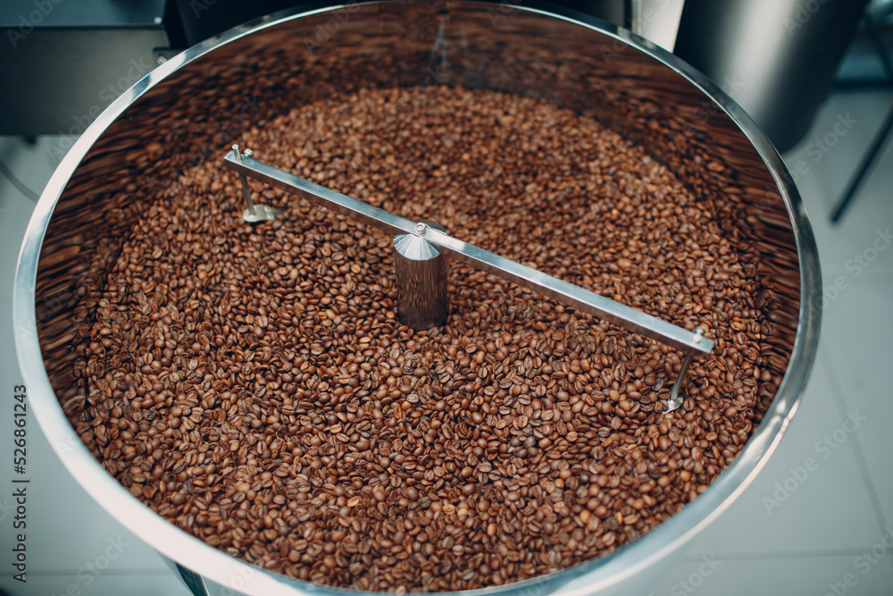 Coffee roaster machine at coffee roasting process. Mixing coffee beans Coffee roaster machine at coffee roasting process. Mixing coffee beans