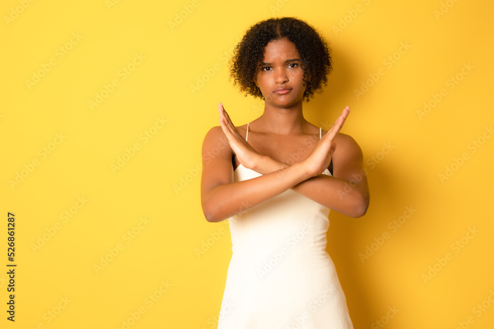 Portrait Of Young Black Female Showing Stop Gesture With Crossed Hands, Serious Millennial African American Woman Refusing Something While Posing Over yellow Studio Background, Copy Space Portrait Of Young Black Female Showing Stop Gesture With Crossed Hands, Serious Millennial African American Woman Refusing Something While Posing Over yellow Studio Background, Copy Space
