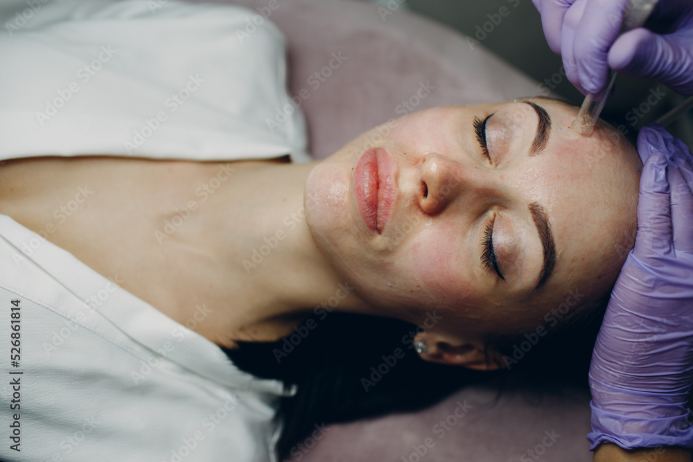 Woman Getting Vacuum Cleaning Face Treatment At Beauty Clinic Woman Getting Vacuum Cleaning Face Treatment At Beauty Clinic