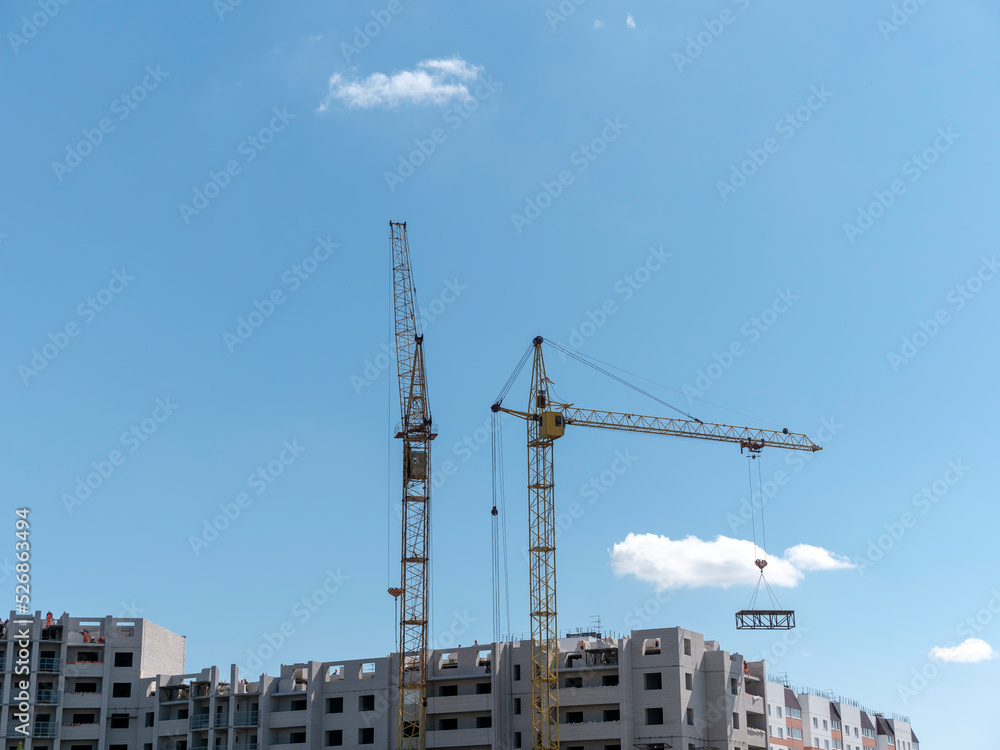 Construction site with many cranes against the sky