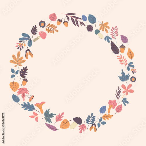Elegant round frame, wreath or border made of colorful fallen oak leaves, acorns, maple, mushrooms, berries and other simple leaves.