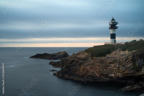 Pancha island lighthouse at sunset in Ribadeo coast, Lugo province, Galicia, Spain