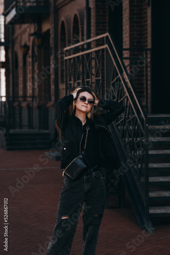 young woman with glasses on the street
