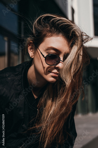 young woman with glasses on the street