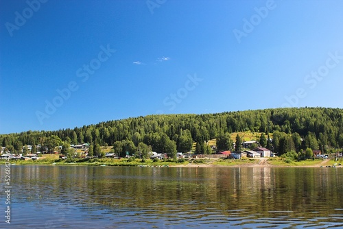 Small summer houses on river bank photo