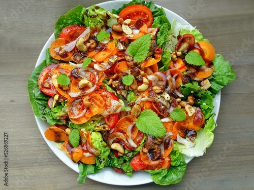 Big colorful power salad plate on white plate top view