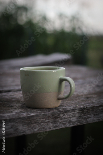 Cup of coffee outdoors on wood table