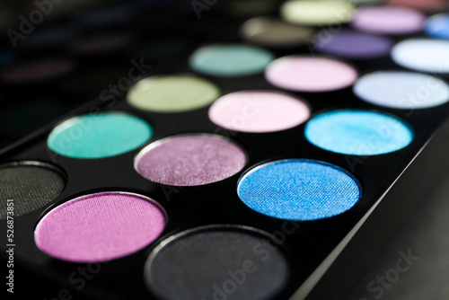 Colorful eyeshadow palette on grey background, closeup