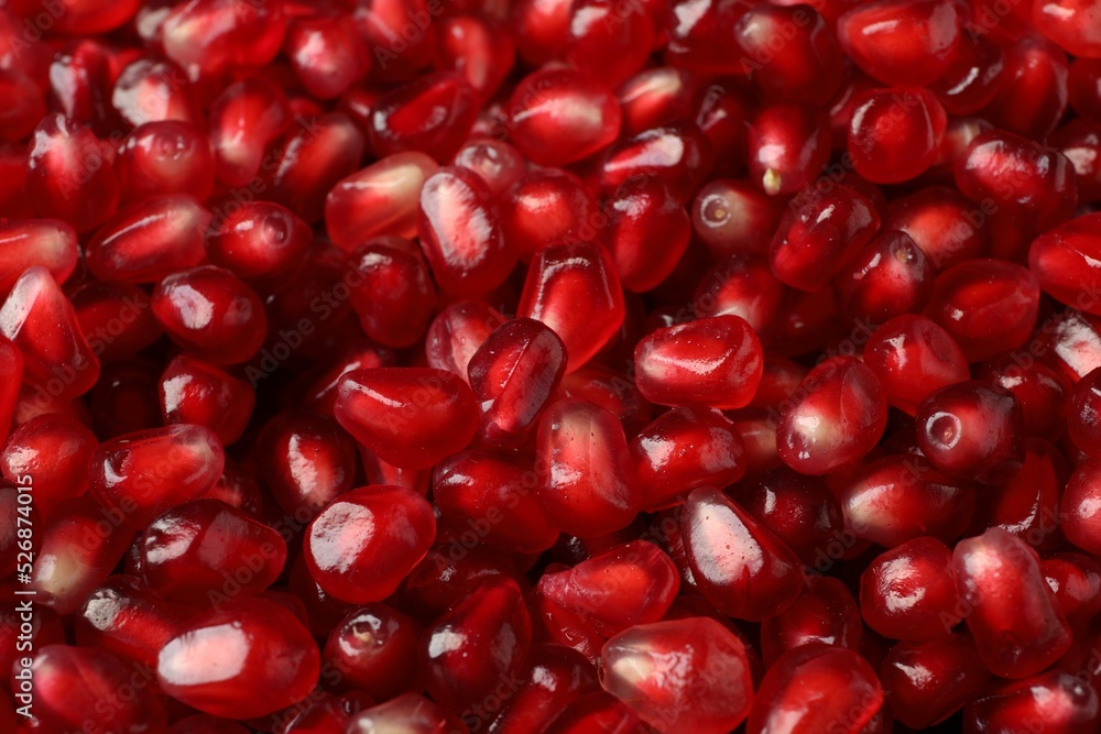 Many tasty pomegranate seeds as background, closeup Many tasty pomegranate seeds as background, closeup