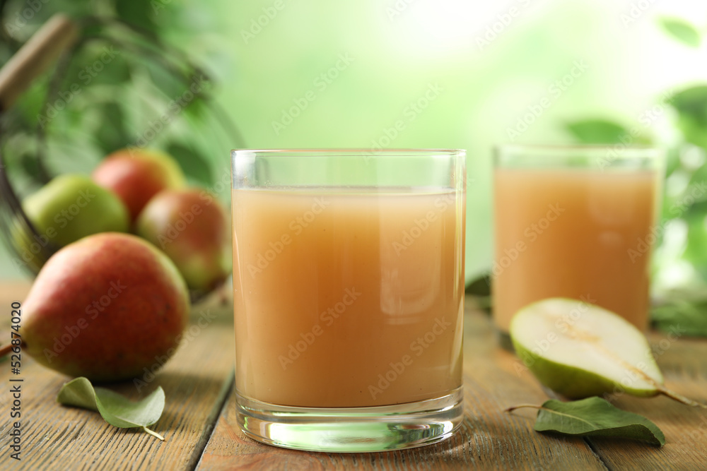 Fresh pear juice in glass on wooden table, closeup Fresh pear juice in glass on wooden table, closeup
