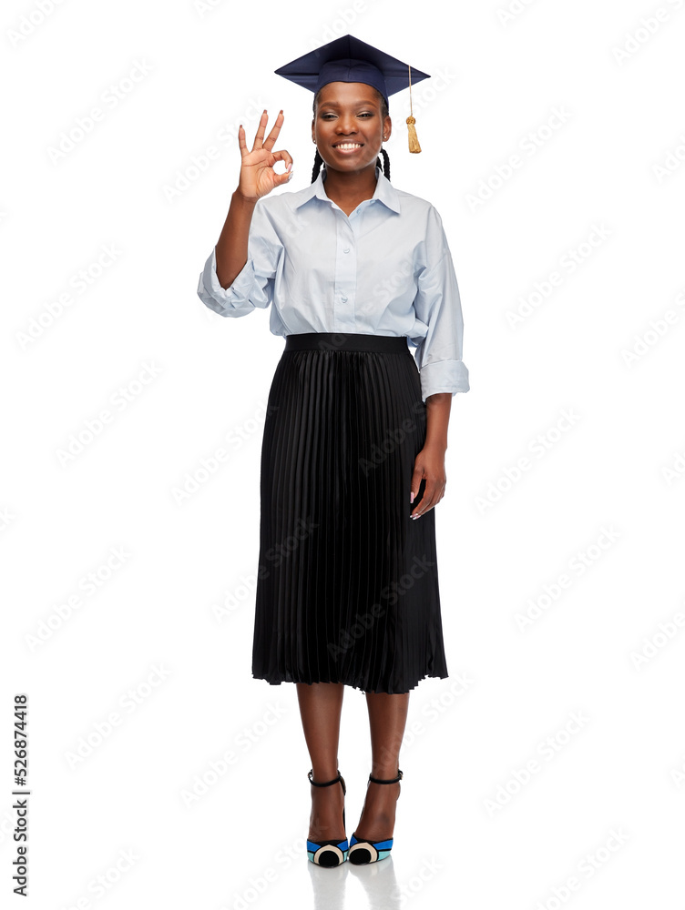 education, graduation and people concept - happy graduate student woman or bachelor in mortarboard showing ok gesture over white background education, graduation and people concept - happy graduate student woman or bachelor in mortarboard showing ok gesture over white background