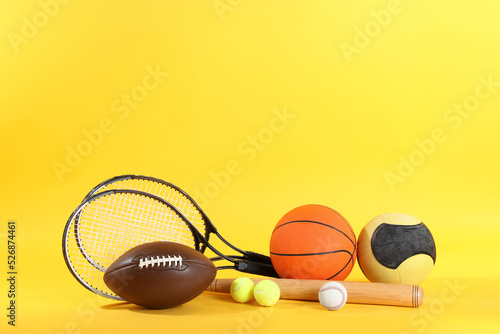 Fototapeta Naklejka Na Ścianę i Meble -  Set of different sports equipment on yellow background