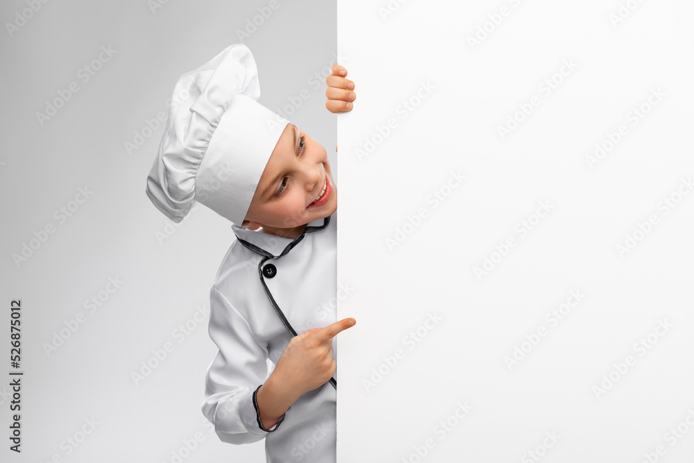 cooking, culinary and profession concept - happy smiling little boy in chef's toque and jacket with white board over grey background cooking, culinary and profession concept - happy smiling little boy in chef's toque and jacket with white board over grey background