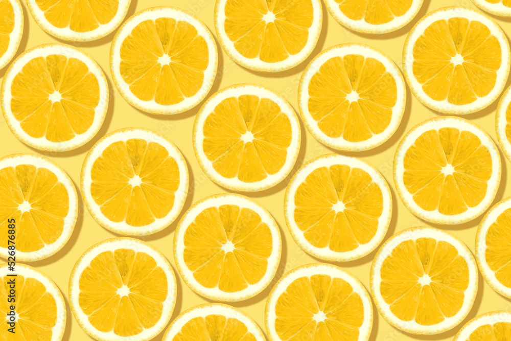 Citrus fruits pattern. Fresh lemon slices on light yellow background Citrus fruits pattern. Fresh lemon slices on light yellow background