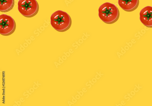 Food concept with copy space. Whole tomatoes on yellow backdrop in top view