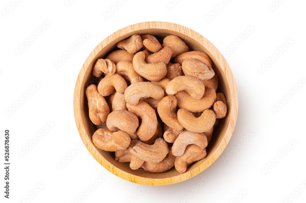 Roasted cashew nuts in wooden bowl on white background. Roasted cashew nuts in wooden bowl on white background.