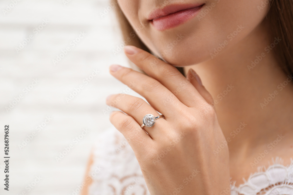 Young bride wearing beautiful engagement ring, closeup Young bride wearing beautiful engagement ring, closeup