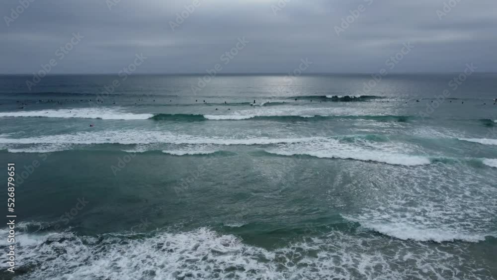 La Jolla Beach, California on a Cloudy Day with Surfers enjoying the Waves La Jolla Beach, California on a Cloudy Day with Surfers enjoying the Waves