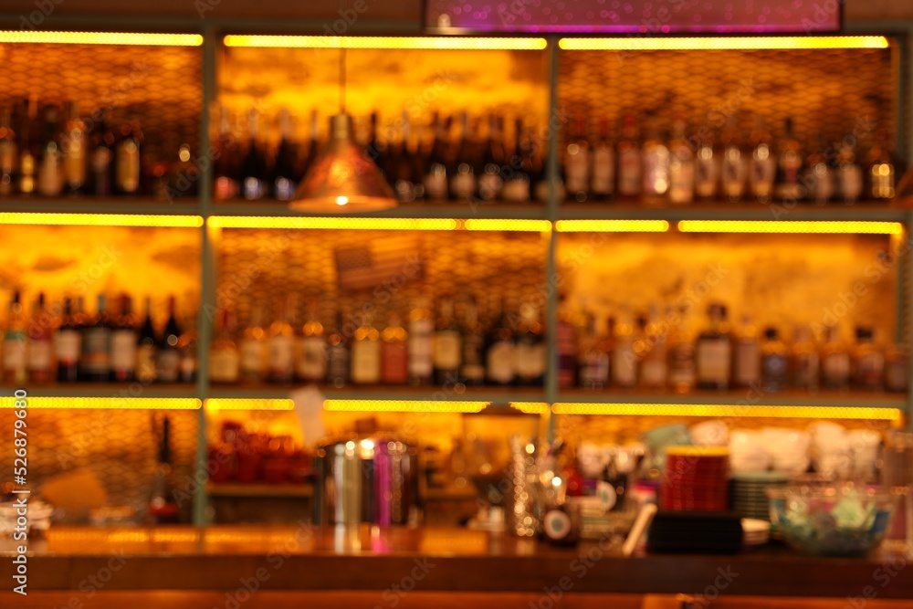 Blurred view of bottles on shelves in bar Blurred view of bottles on shelves in bar