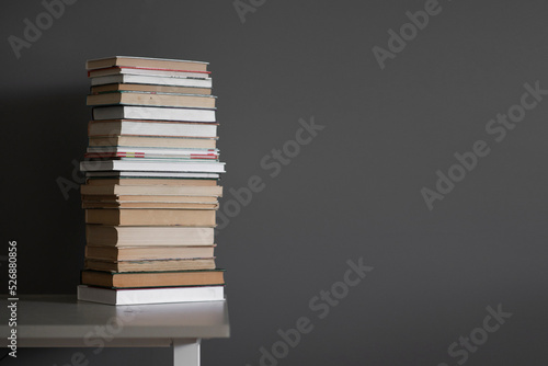 a stack of books on the shelf, concept of homework and studying