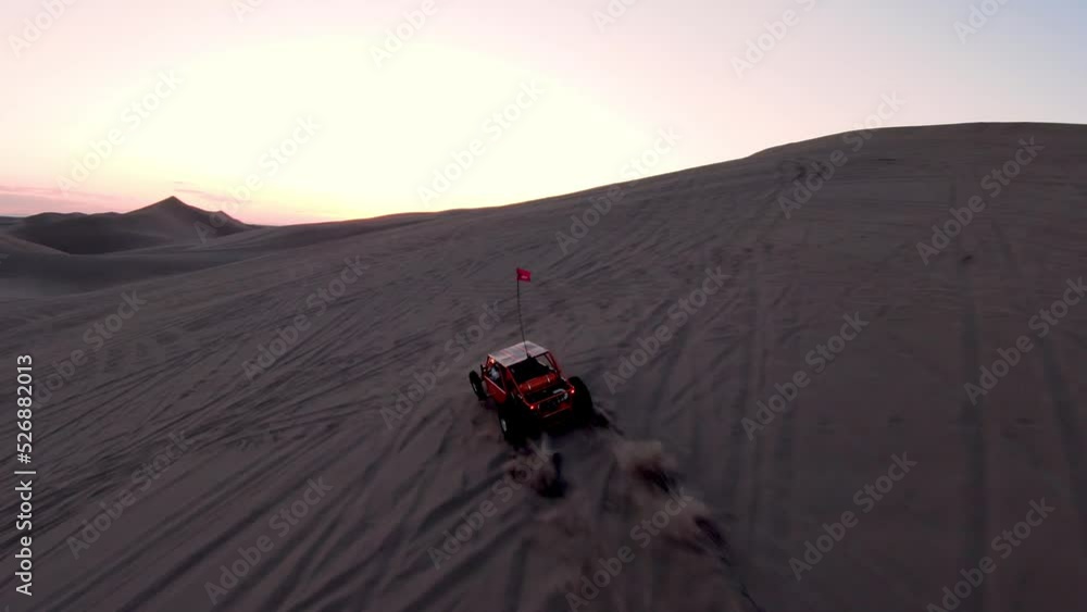 Offroad Dune Buggy driving in the desert Sand Dunes at dusk Offroad Dune Buggy driving in the desert Sand Dunes at dusk