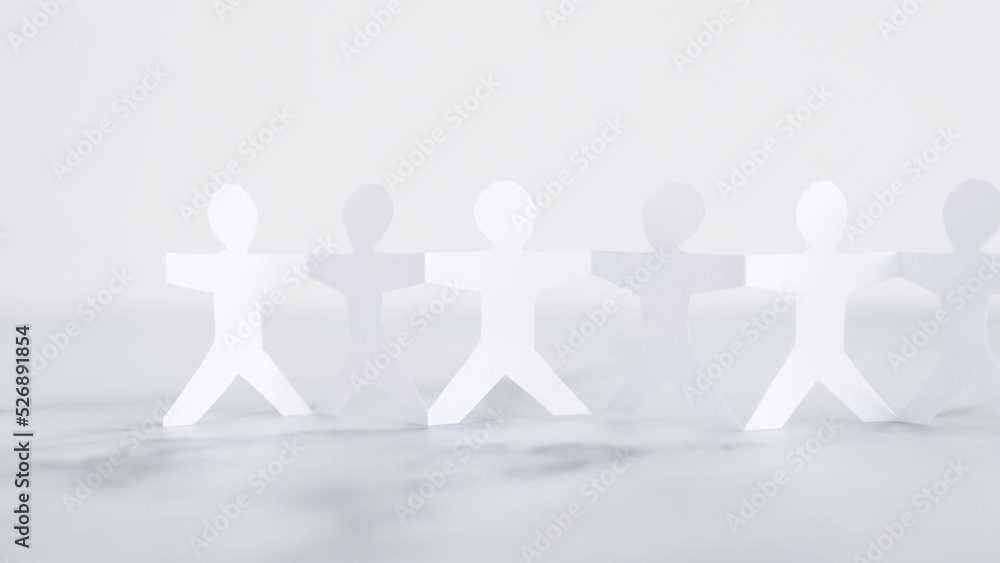 manpower and teamwork, paper people chain with text on white marble background manpower and teamwork, paper people chain with text on white marble background
